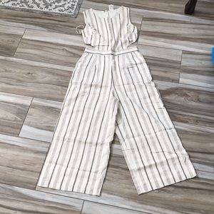 Cream/black jumpsuit with size waist openings. Has back zipper. Wide leg. NWT